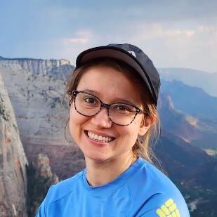 Image of Krista's smiling face with a Utah canyon in the background